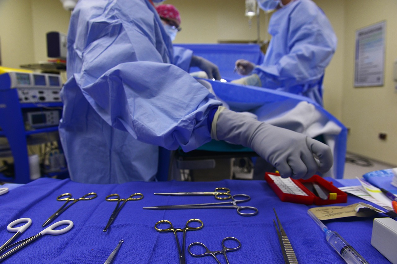 three medical professionals performing surgery